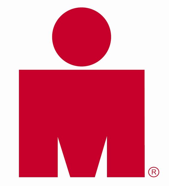 The Ironman race logo: a red circle on top of a red rectangel that has two triangular slots cut out of the bottom so that it resembles the letter M.